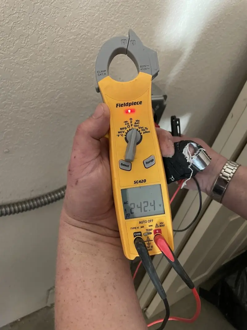 Voltage testing with clamp meter during Outlet Installation in Le Roy